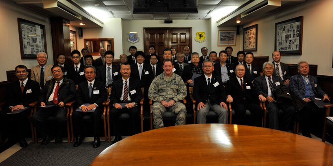 U.S. Air Force Brig. Gen. James Hecker, 18th Wing commander, and members of Japan-America Air Force Goodwill Association take a group photo after a briefing on Kadena Air Base, Japan, March 4, 2014. The group was made up of 32 JAAGA members, who are retired Japanese Air Self-Defense Force including three retired lieutenant generals, two retired major generals, a retired colonel and 23 cooperative associate members and three of the attendees are individual JAAGA members. (U.S. Air Force photo by Naoto Anazawa)