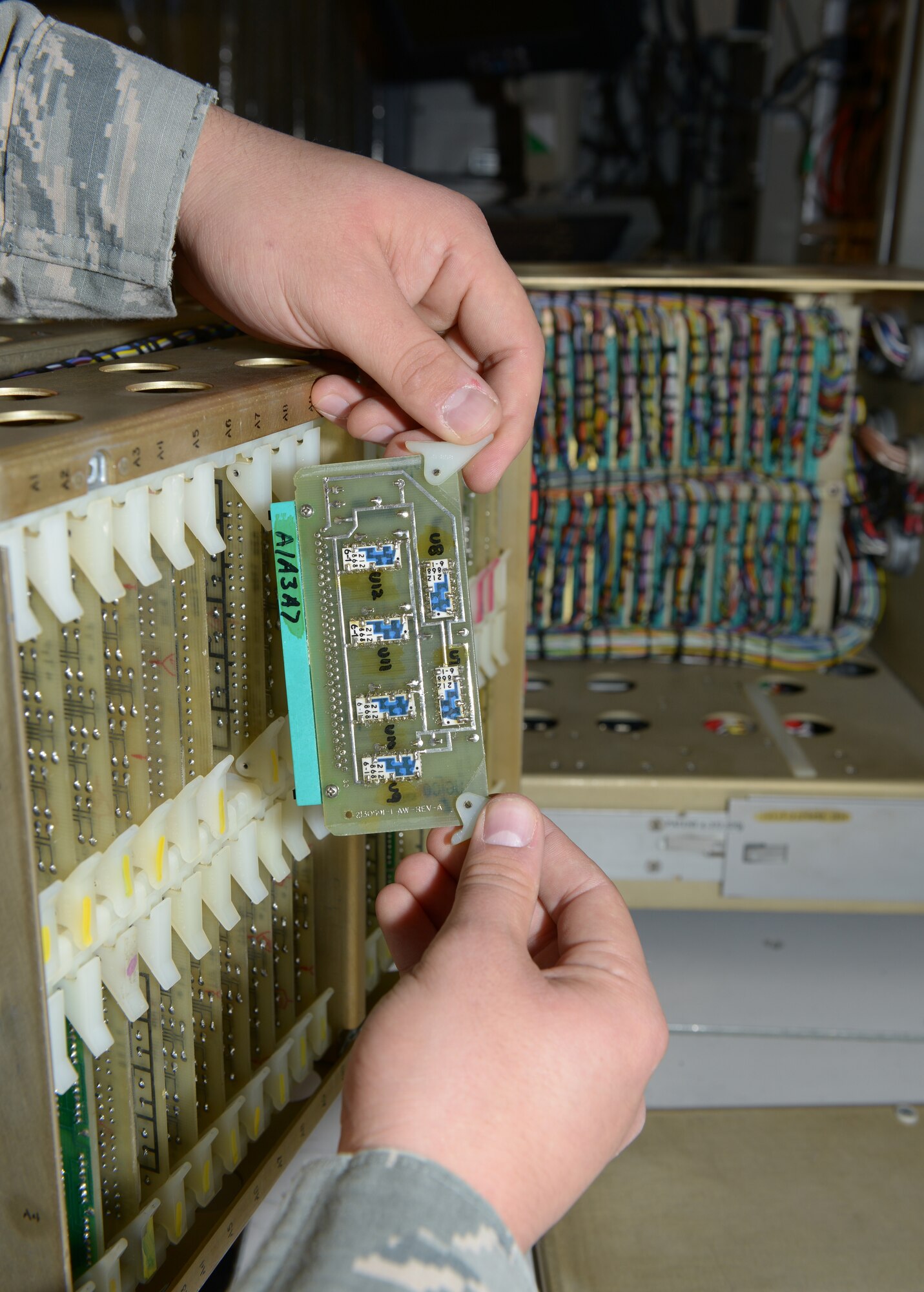 Staff Sgt. Allen Orr inspects a component at Al Udeid Air Base, Qatar, Mar. 4, 2014. The component is used in the avionics aboard an F-15E Strike Eagle. The 379th Expeditionary Maintenance Squadron avionics flight houses the only avionics repair facility throughout the U.S. Air Forces Central Command area of responsibility. Orr, 379th EMXS F-15 avionics team leader, is deployed from Seymour Johnson Air Force Base, N.C., and a Sault Ste. Marie, Mich., native. (U.S. Air Force photo/Senior Airman Hannah Landeros)