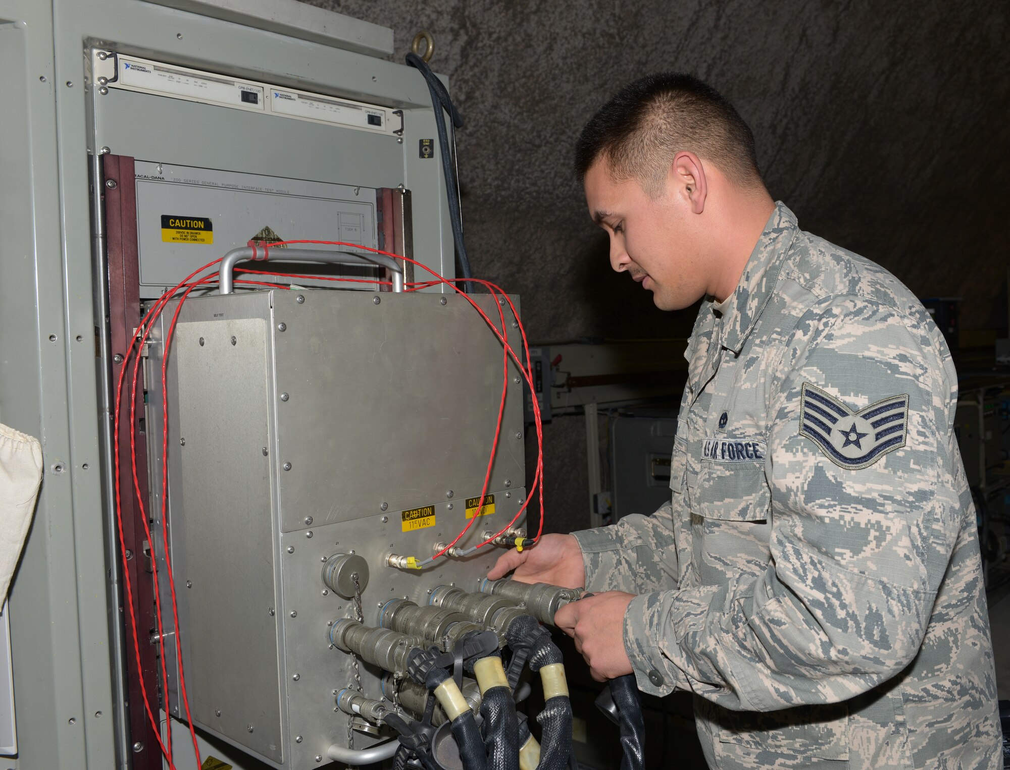 Staff Sgt. Allen Orr connects a test package cable to an interface test adapter at Al Udeid Air Base, Qatar, Mar. 4, 2014. The interface test adapter is used by avionics Airmen to troubleshoot line replaceable units that need repairs. The 379th Expeditionary Maintenance Squadron avionics flight houses the only avionics repair facility throughout the U.S. Air Forces Central Command area of responsibility. Orr, 379th EMXS F-15 avionics team leader, is deployed from Seymour Johnson Air Force Base, N.C., and a Sault Ste. Marie, Mich., native. (U.S. Air Force photo/Senior Airman Hannah Landeros)