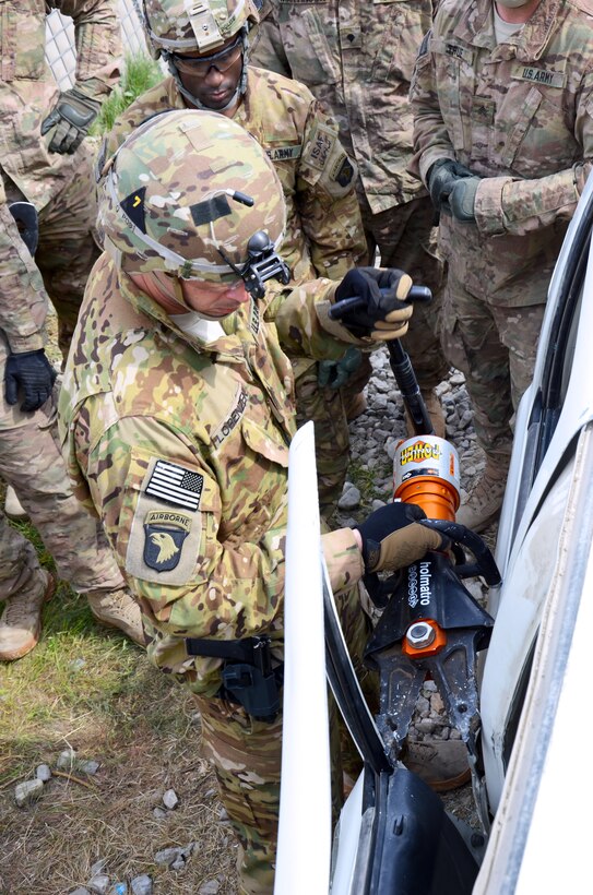 U.S. Army Sgt. Henry Lorenzen, a flight medic, uses a Jaws of Life spreader to pry open the door of a Ford Ranger truck during vehicle extraction training on Forward Operating Base Fenty, Afghanistan, Feb. 25, 2014. Lorenzen, a flight medic, is assigned to 101st Airborne Division's 159th Combat Aviation Brigade.