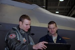 U.S. Air Force Lt. Col. Michael Schaner, Virginia Air National Guard 192nd Fighter Wing F-22 Raptor pilot, reviews aircraft forms with U.S. Air Force Senior Airman Jaymes Baum, 94th Aircraft Maintenance Squadron, before a mission at Joint Base Langley-Eustis, Jan. 28, 2014.