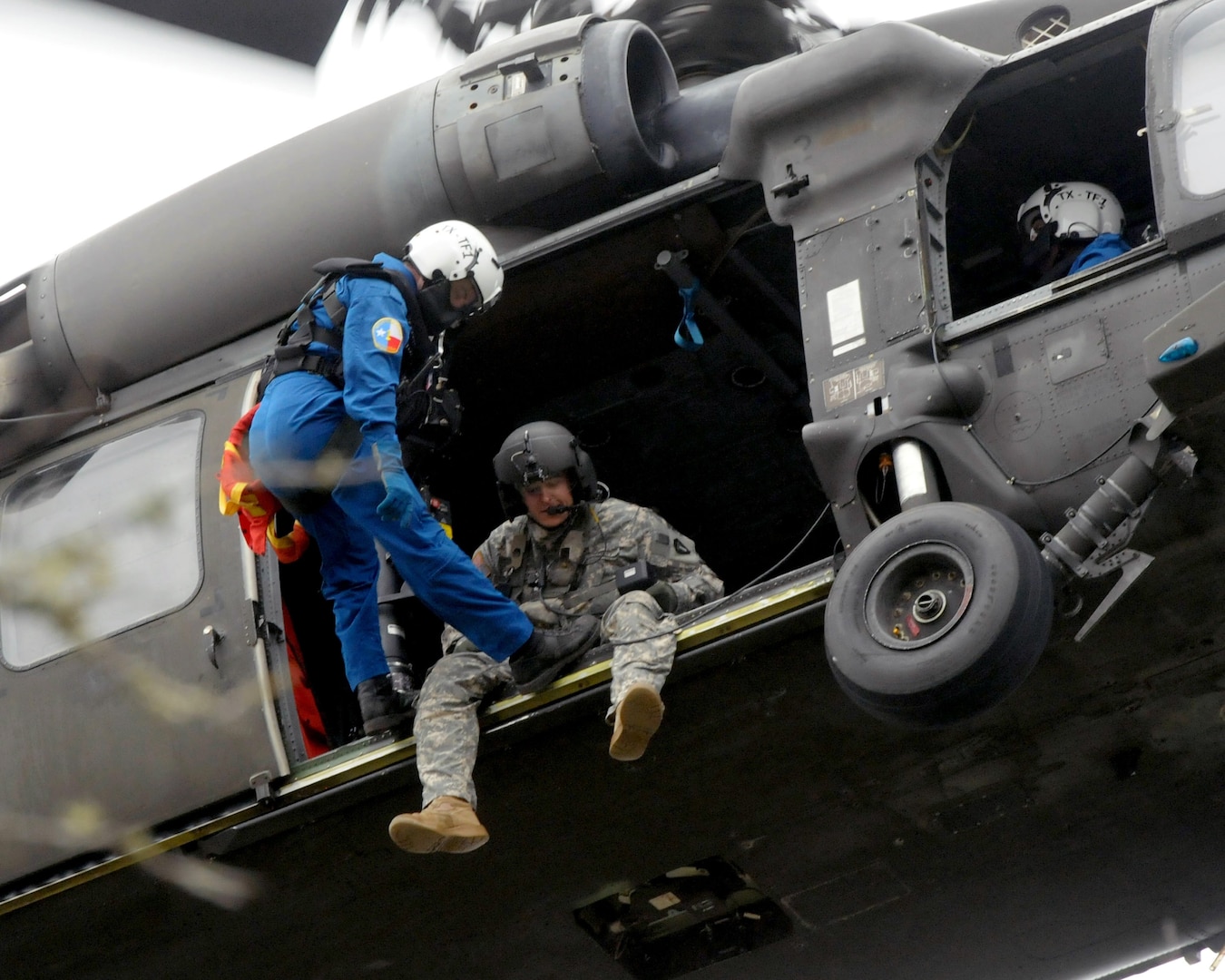 Sgt. Kevin McLaughlin, 36th Combat Aviation Brigade, lowers a member of Texas Task Force-1 into a tree line as part of a combined training event between the 36th Combat Aviation Brigade and Texas Task Force-1. The units trained on search and extraction techniques used during hurricanes and other natural disasters.