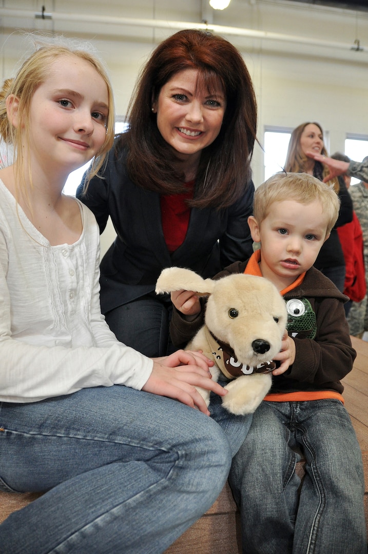Lt. Gov. Rebecca Kleefisch spends some time with 11-year-old Hannah Hendrickson of Prescott, Wis., and her 2-year-old brother Aaron after a formal sendoff ceremony Feb. 22 at Camp Williams, Wis. The children of more than 60 32nd Infantry Brogade Combat Team Soldiers received plush toy dogs called G.I. Josh, and Kleefisch encouraged the children to send in photos of themselves with the toy dogs while their loved ones are deployed to the Middle East.