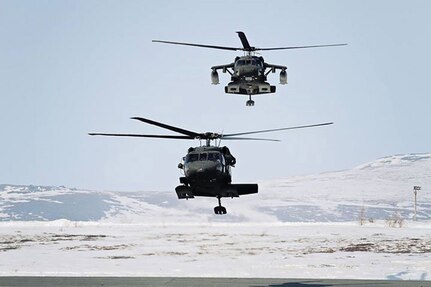 A pair of Alaska Army National Guard UH-60 Black Hawk helicopters taxi after pilots land at the Alaska Army National Guard Army Aviation Support Facility in Nome April 17, 2012. Similar craft assisted a stranded snow machine rider Saturday.