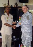 Brig. Gen. Abalo Kadangha, chief of defence staff for the Togolese Armed Forces, presents Maj. Gen. David Sprynczynatyk, North Dakota adjutant general, with a memento Jan. 14, 2014 during Sprynczynatyk's visit to the Togolese Republic.