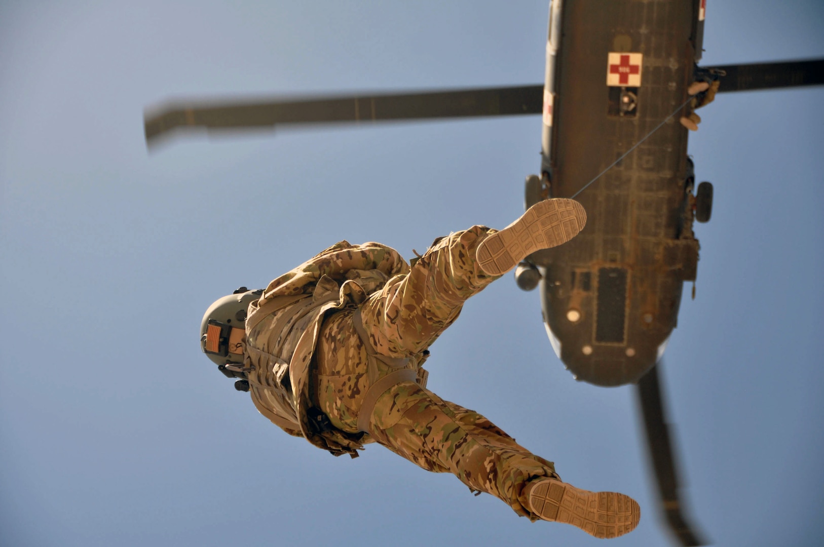 Sgt. 1st Class Dave Cornell from Charlie Company 1-168th (C Company 1-168) General Support Aviation Battalion is hoisted aloft to a UH-60 Black Hawk demonstrating a single-man rescue during hoist training.