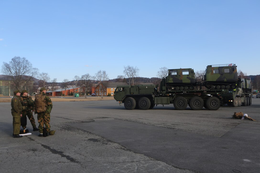 Norwegian soldiers with Host Nation Support Battalion look over Logistics Vehicle System Replacements, which belong to 2nd Supply Battalion, Combat Logistics Regiment 25, 2nd Marine Logistics Group, at Vaernes Garrison, Norway, March 2, 2014. HNSB and 2nd Supply Bn. integrated operational forces in support of Cold Response 2014 to increase interoperability and efficiency of resource allocation. Cold Response 2014 is a Norwegian-led multinational exercise above the Arctic Circle designed prepare for crisis-response operations.