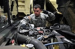 A Virginia National Guard Soldier conducts maintenance checks on a Humvee to prepare for possible winter storm response operations March 3, 2014, in Fredericksburg, Va.