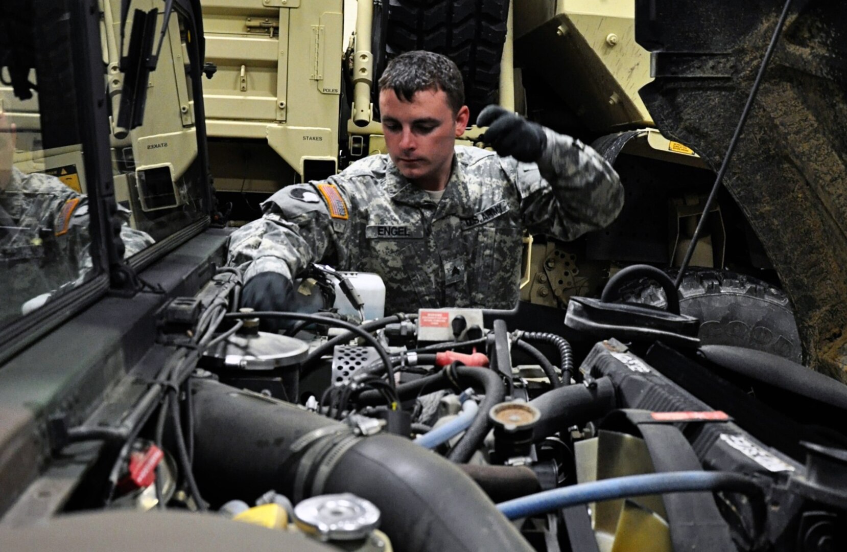 A Virginia National Guard Soldier conducts maintenance checks on a Humvee to prepare for possible winter storm response operations March 3, 2014, in Fredericksburg, Va.