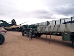 Army Staff Sgts. Joaquin Lopez, left, and Ruben Cruz, assigned to the Arizona Army National Guard’s 2220th Transportation Company, offload concrete barriers in Naco, Ariz., near the Arizona-Mexico border, March 1. The Soldiers partnered with U.S. Customs and Border Protection to deliver the barriers from El Centro, Calif., as a way to accomplish training on convoy operations while supporting CBP efforts along the border.