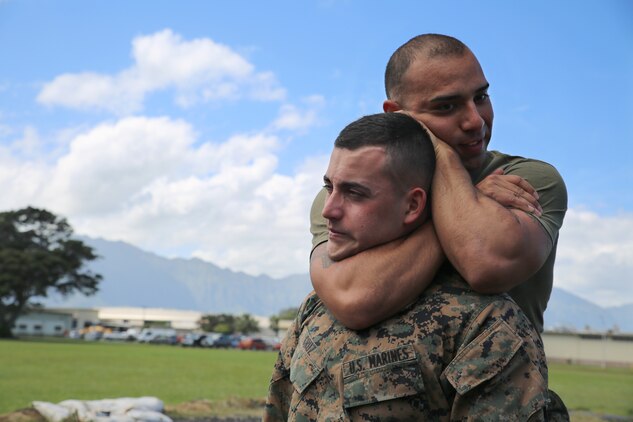 Sgt. Rey Campos, a platoon sergeant with the distribution management office and a Marine Corps Martial Arts Program instructor, performs a choke hold on Lance Cpl. Santiago Cruz, a distribution management clerk, March 5, 2014. (U.S. Marine Corps photo by Lance Cpl. Suzanna Knotts) 