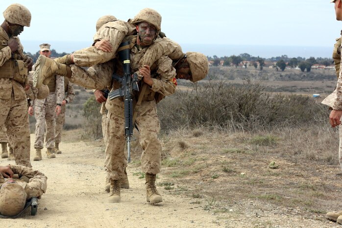 Pfc. William N. Cunningham, Platoon 2111, Company E, 2nd Recruit Training Battalion, fireman carries another Marine in the course of a casualty evacuation drill during the Crucible at Edson Range aboard Marine Corps Base Camp Pendleton, Feb. 26. Cunningham has sought to become a Marine since 2008.