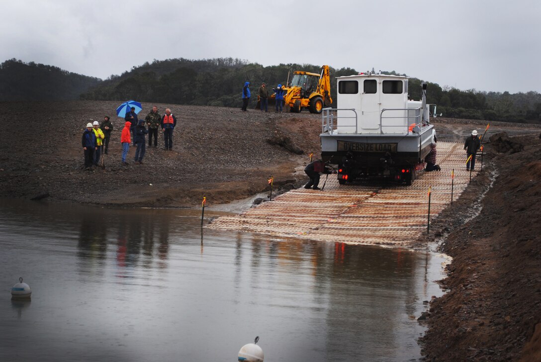 U.S. Army Corps of Engineers San Francisco District maintenance crew unloads its barge boat at Lake Mendocino Feb. 27 as part of its emergency operations for Redwood Valley County Water District to use as a floating platform to extend its ability to supply water to 4,000 residents.   With drought water levels hovering around 30 percent of capacity, gravel and circa World War II pierced-steel planks transformed the exposed lake bed into a temporary boat ramp.  The 21st Engineers (Aviation) Regiment constructed a portable pierce-steel plank runway in 1941 which is the same system used during the Battle of Midway in the South Pacific.