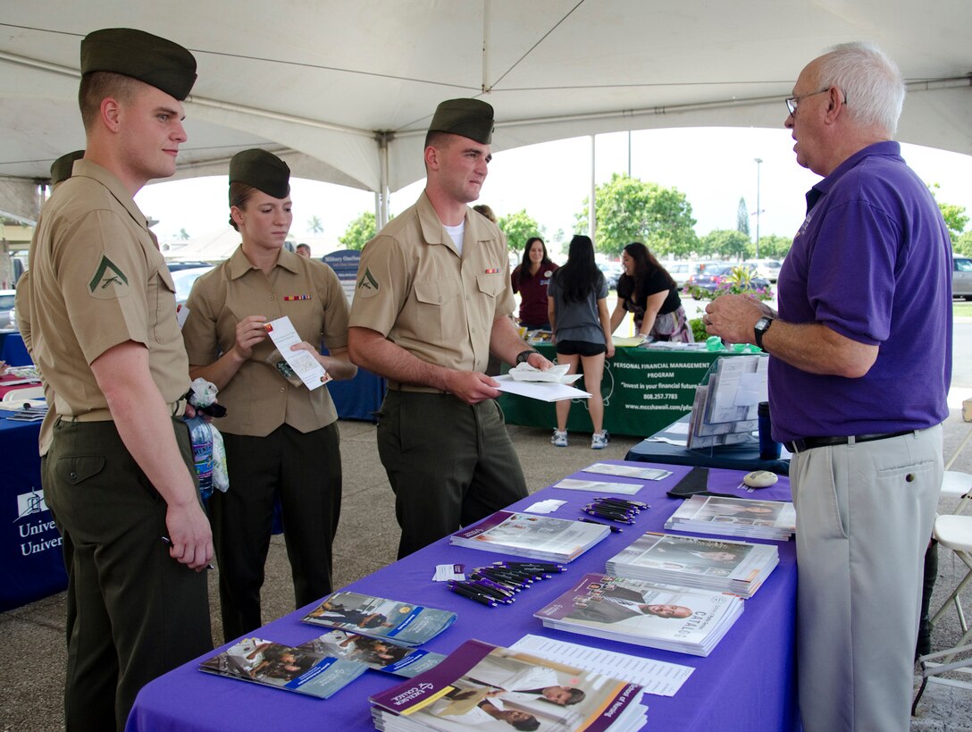 Marines chat with Jim Lehmkuhler, military education consultant at the Excelsior College booth, during the Education and Finance Expo at Mokapu Mall, Feb. 28, 2014. More than 240 people attended the expo, which included more than 30 financial organizations, universities and colleges, Marine Corps Community Services and other entities. Attendees were able to chat with representatives from the various organizations, and answer trivia questions for prizes. The Career and Education Fair is scheduled for June 20, and the fall Education Fair is scheduled to take place in August. (U.S. Marine Corps photo by Kristen Wong)