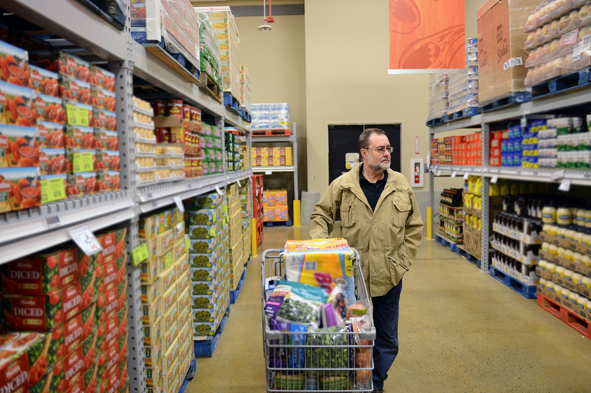 Edward Fisher, Army retiree shops the Commissary Club section during its grand opening March 7, 2014 at Joint Base Lewis-McChord, Wash. The new Commissary Club is an addition at the back of the McChord Field Commissary sales floor and is open to all Department of Defense ID card holders. (U.S. Air Force Photo/Airman 1st Class Jacob Jimenez)