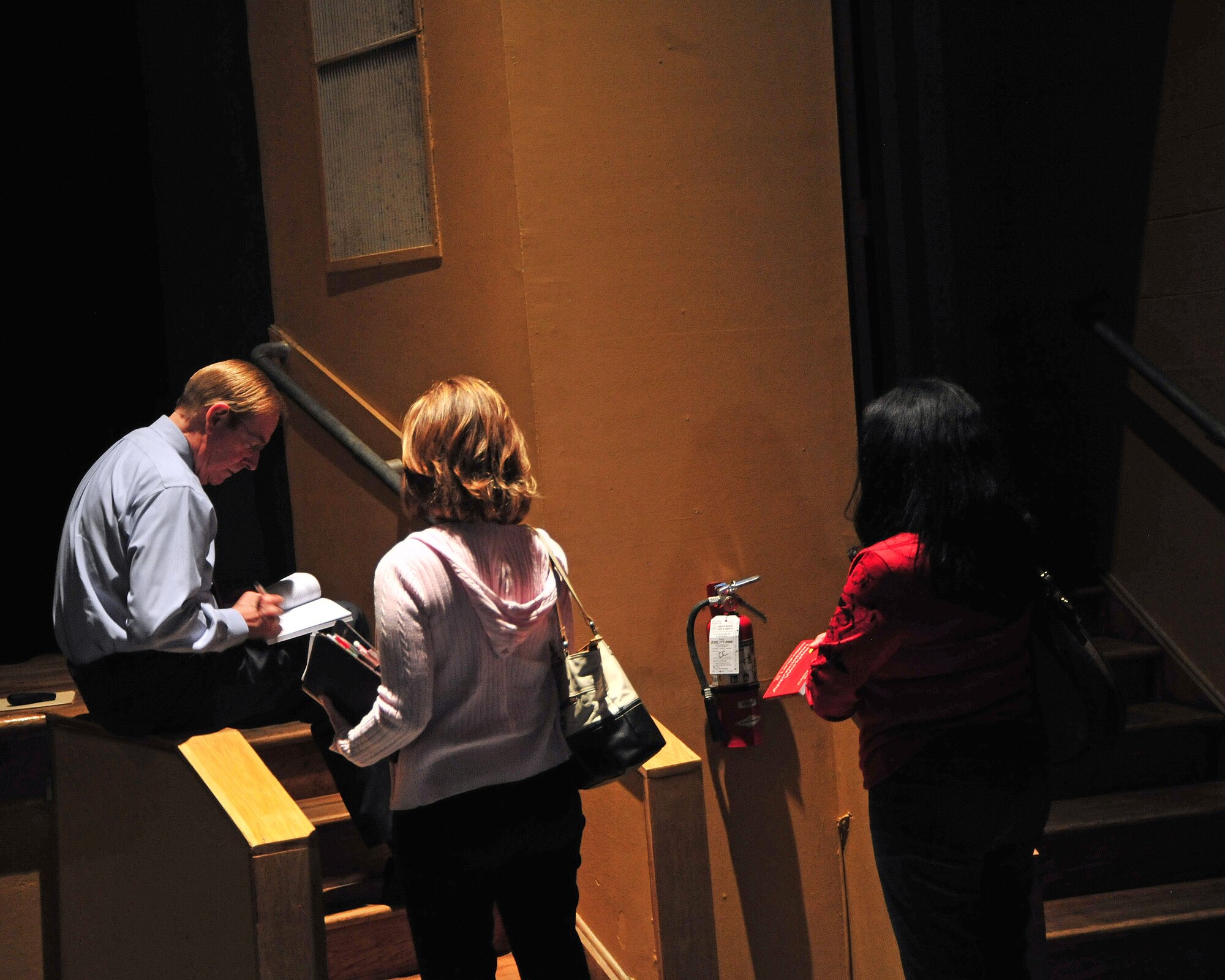Dr. Gary Chapman, author, signs copies of“The 5 Languages of Appreciation in the Workspace” after his seminar at the base theater on Davis-Monthan Air Force Base, Ariz., March 7, 2014. A copy of his book was given out to everyone in attendance. (U.S. Air Force photo by Senior Airman Josh Slavin/Released)