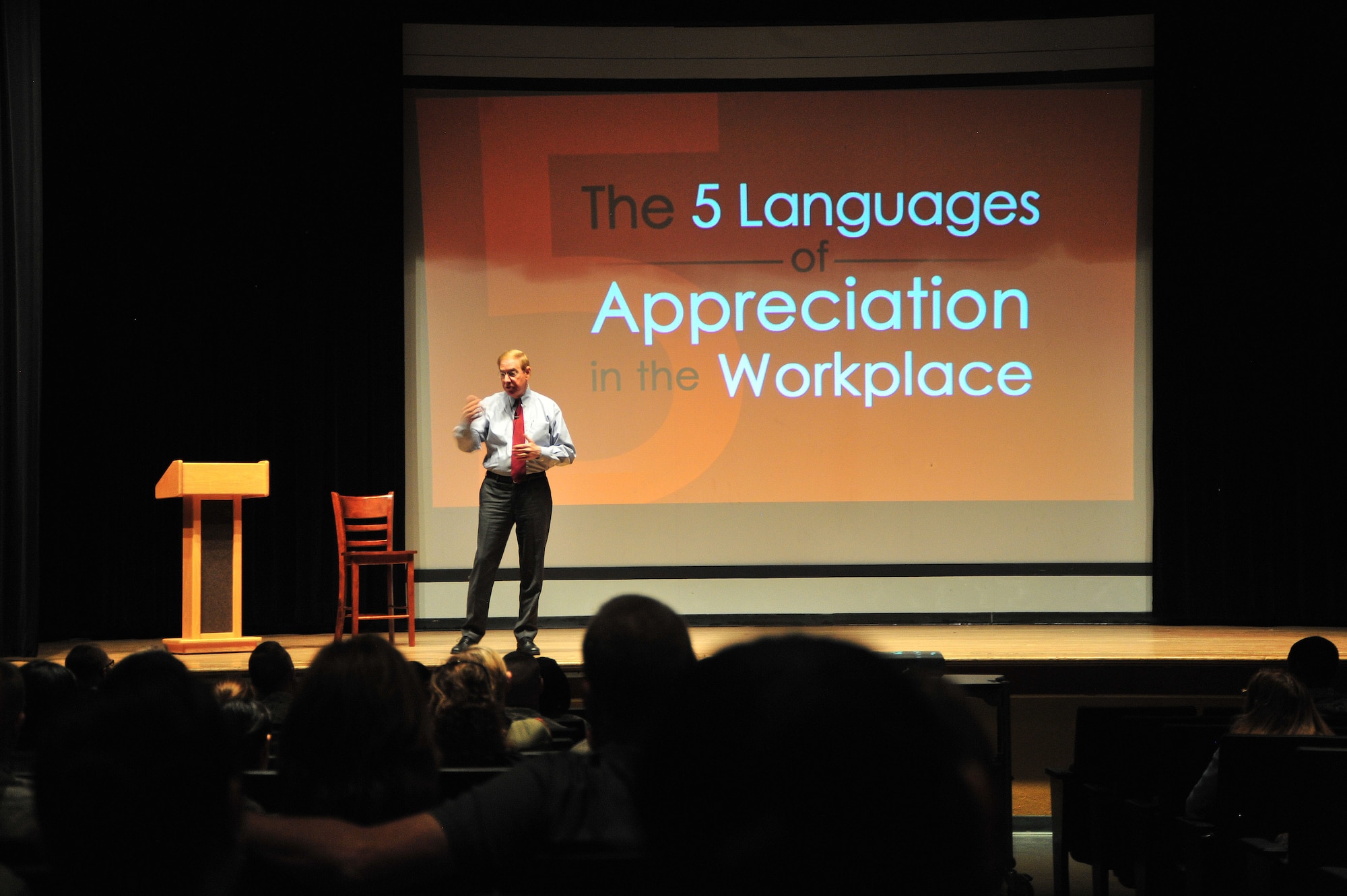 Dr. Gary Chapman, author, speaks to nearly 200 Airmen at the base theater on Davis-Monthan Air Force Base, Ariz., March 7, 2014. Chapman discussed his book “The 5 Languages of Appreciation in the Workspace” and the different ways to express appreciation. (U.S. Air Force photo by Senior Airman Josh Slavin/Released)