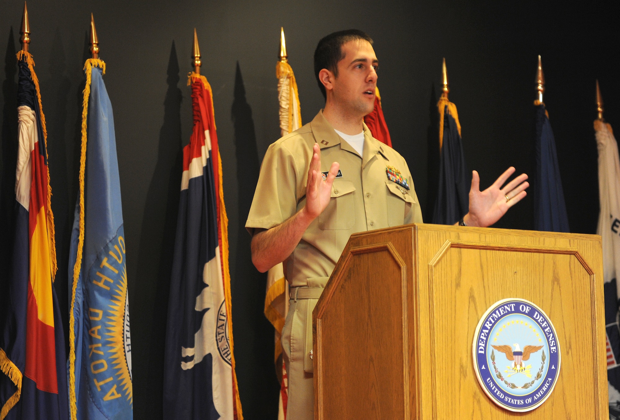 U.S. Navy Lt. Joseph Abdullah, Denver Military Entrance Processing Station operations officer, speaks with the applicants after their Oath of Enlistment ceremony March 4, 2014, at the Denver MEPS in Denver. The Oath of is given to any person enlisting or re-enlisting for a term of service into any branch of military. (Air Force photo by Emily E. Amyotte/Released)