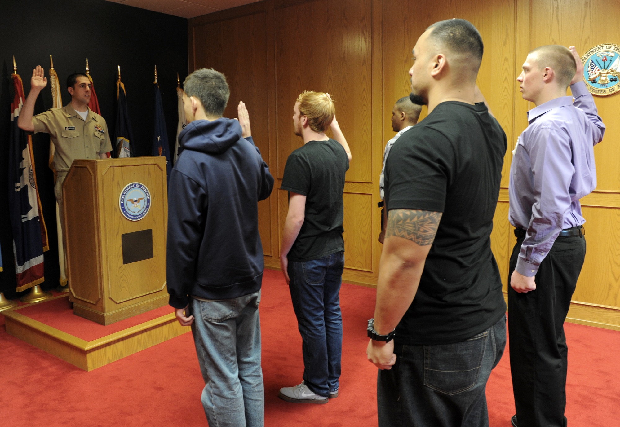 U.S. Navy Lt. Joseph Abdullah, Denver Military Entrance Processing Station operations officer, administers the Oath of Enlistment March 4, 2014, at the Denver MEPS in Denver. The Oath of Enlistment is given to any person enlisting or re-enlisting for a term of service into any branch of military. (Air Force photo by Airman Emily E. Amyotte/Released)