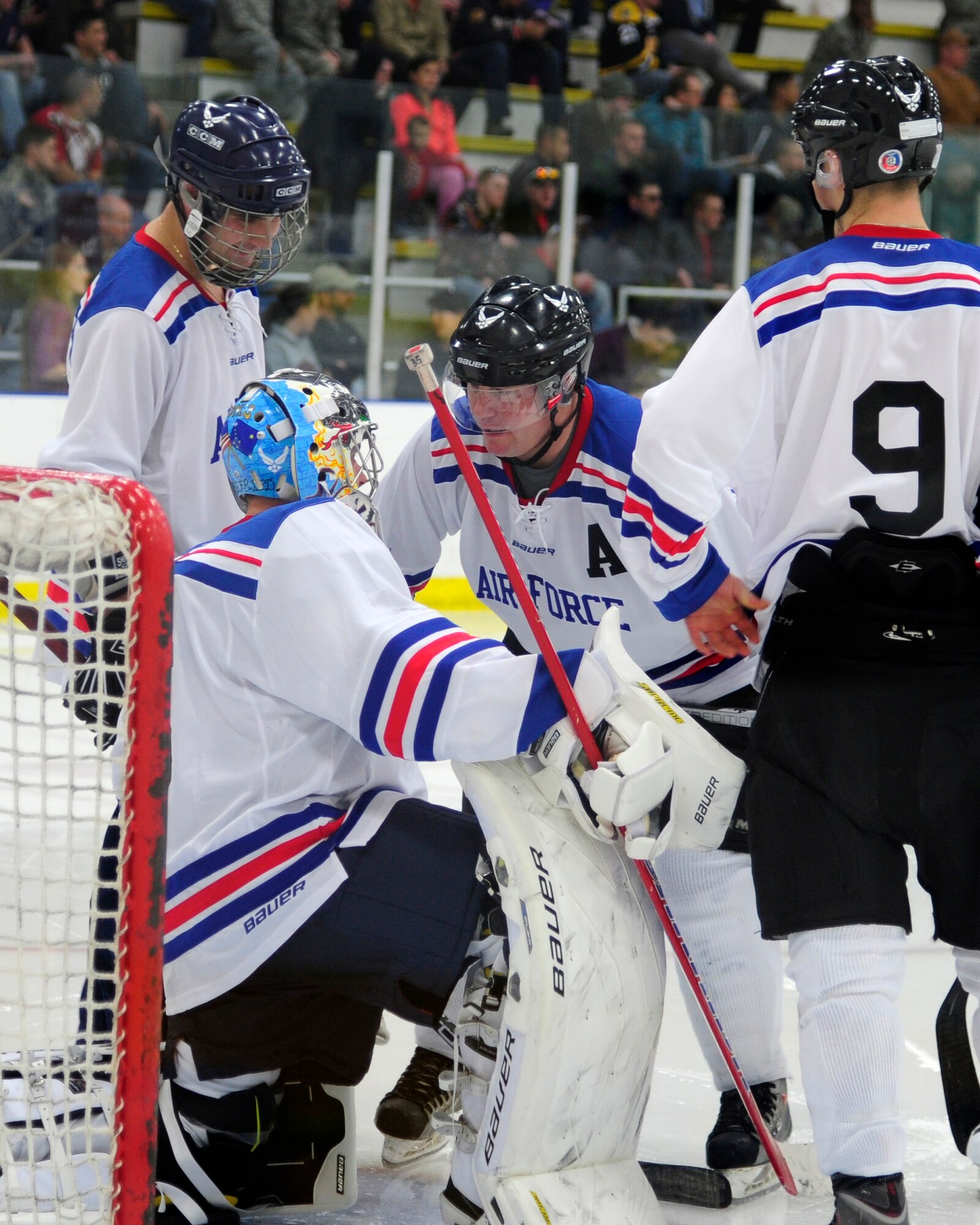 Eielson defenseman Chris Malenius speaks with Charlie Siegfred, Eielson goalie, at the start of the third period of the Commanders’ Cup hockey game at the University of Alaska Fairbanks Patty Center, Feb. 28, 2014, Fairbanks, Alaska. The Eielson Icemen beat the Interior Alaska-Based Army Hockey Team 8-5, claiming the Commanders’ Cup for the second year in-a-row. (U.S. Air Force photo/Tech. Sgt. Tim Jenkins)