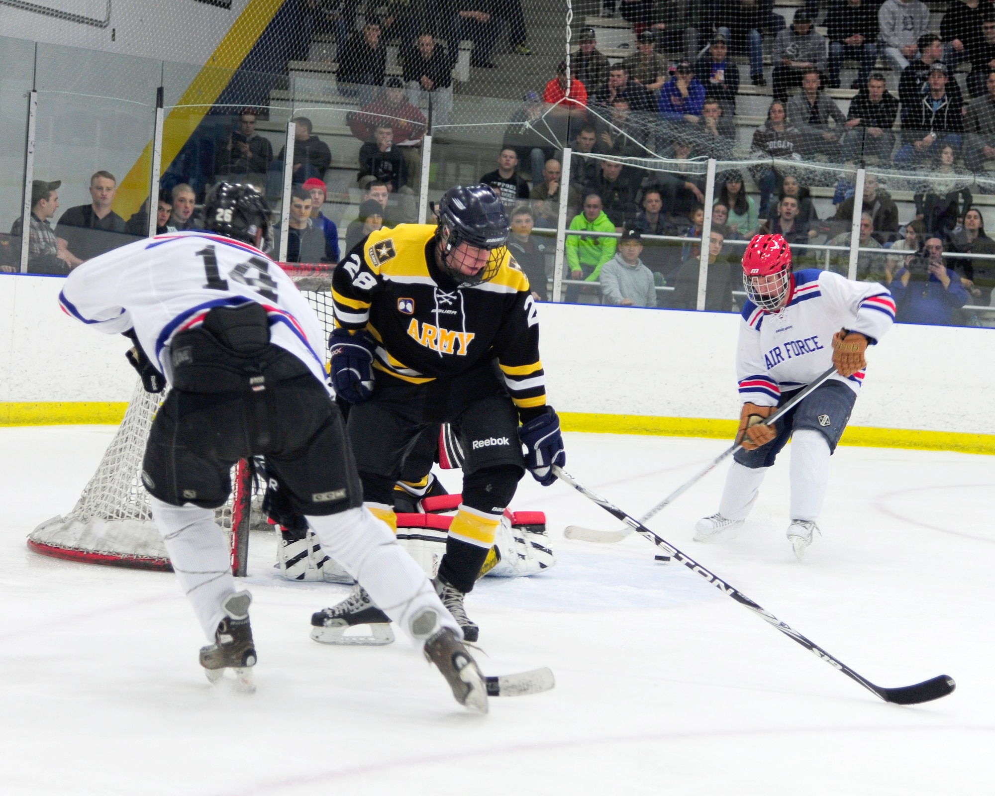 Skylar Chupp, Eielson right wing, sends a pass to Erik Fitzstephens, Eielson defenseman, during the second period of the Commanders’ Cup hockey game at the University of Alaska Fairbanks Patty Center, Feb. 28, 2014, Fairbanks, Alaska. The Eielson Icemen scored 2 shorthanded goals in the period, earning an 8-5 win over the Interior Alaska-Based Army Hockey Team. (U.S. Air Force photo/Tech. Sgt. Tim Jenkins)