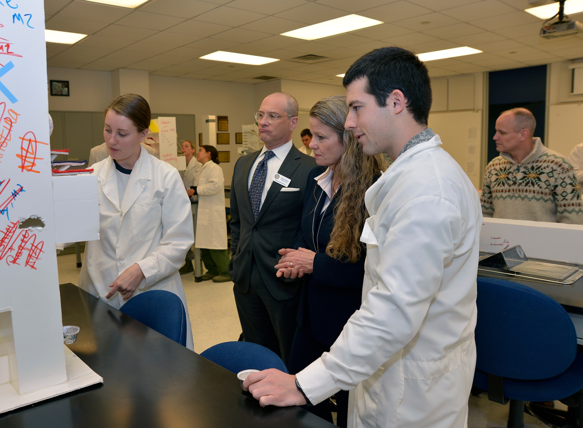 Stuart Feinhor (middle, left) , constituent advocate for U.S. Representative Jared Polis (Colo.), and Tina Strickland, the Air Force Accessions and Training Management chief (middle, right), are seen here with cadets in the Academy's behavioral Sciences Laboratory March 6. Feinhor and Strickland toured the laboratory during the Academy's annual Board of Visitors visit here, March 6 - 7. (Sam Lee/Air Force photo)