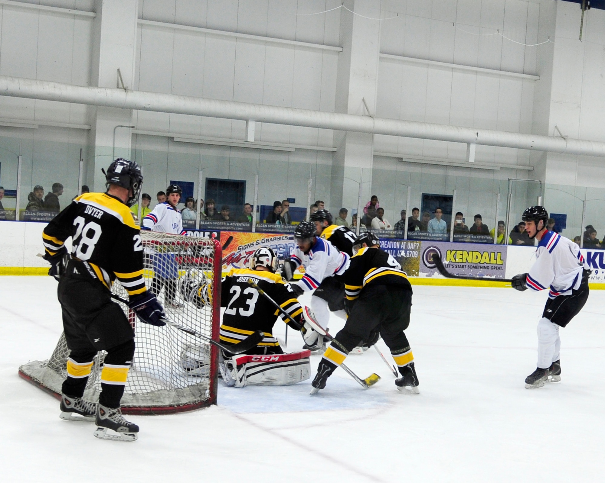 Cody King, Eielson right wing, pushes the puck past Travis Johnson, Interior Alaska-Based Army Hockey Team goalie, scoring the first point of the game in the first period of the Commanders’ Cup hockey game at the University of Alaska Fairbanks Patty Center, Feb. 28, 2014, Fairbanks, Alaska. The Eielson Icemen beat Army 8-5, claiming the Commanders’ Cup for the second year in-a-row and 10th time overall. (U.S. Air Force photo/Tech. Sgt. Tim Jenkins)