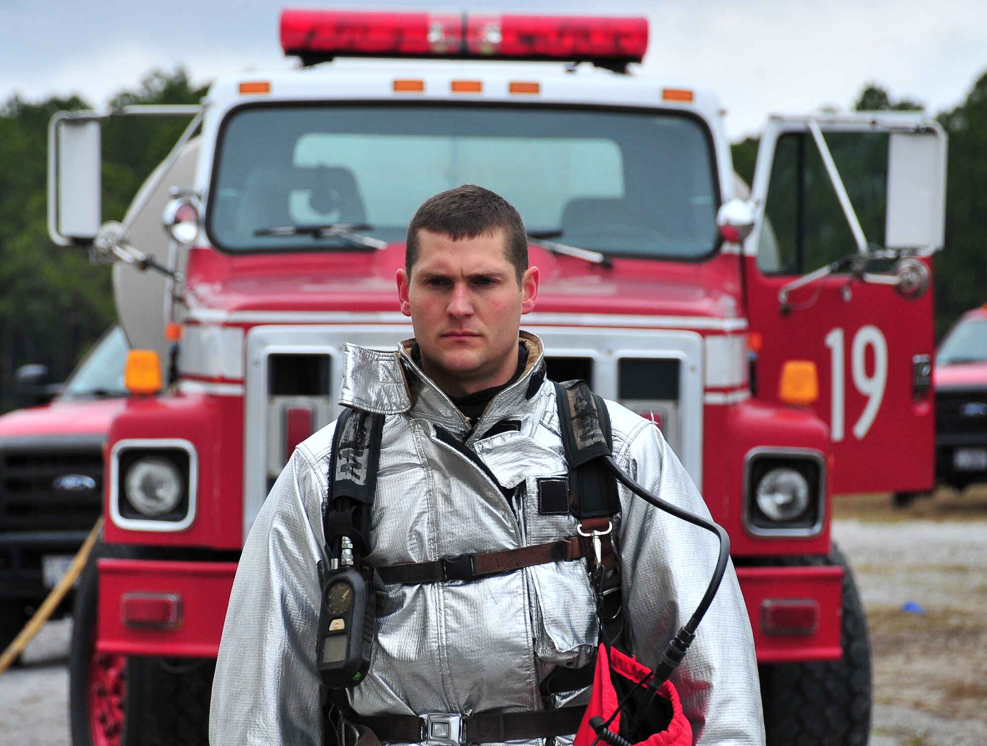 Airman 1st Class Bradley Gettel, 325th Civil Engineer Squadron fire and emergency services fire protection apprentice, stands in front of a firefighter vehicle March 7 at the Fire Department Training area. Gettel conducts firefighting operations on a four-man crew charged with structural and aircraft rescue firefighting and  provides support if hazardous material and technical rescue response is needed. (U.S. Air Force photo by Airman 1st Class Sergio A. Gamboa)