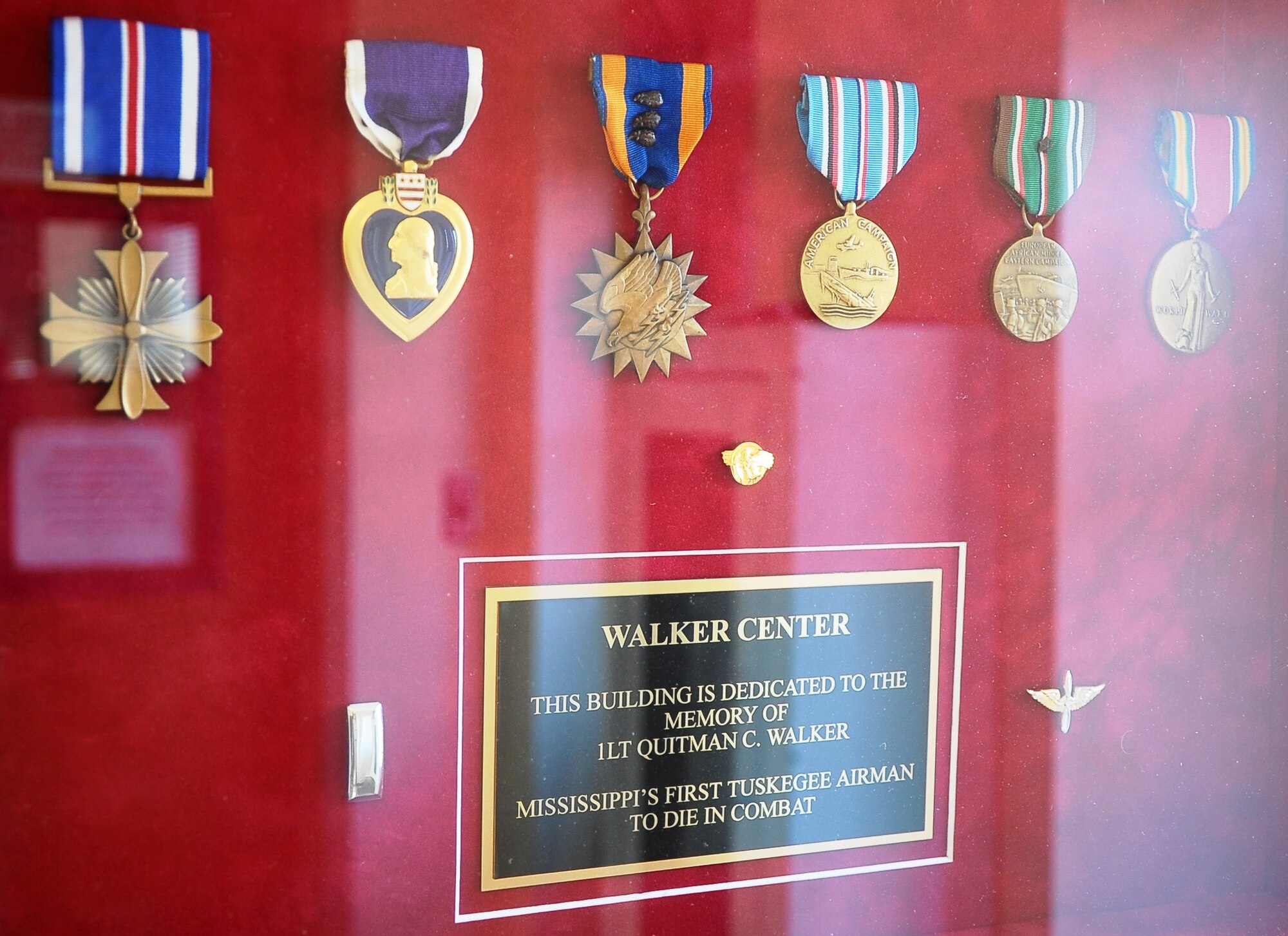 A shadowbox inside Walker Center holds 1st Lt. Quitman Walker’s medals, his dedication plaque and a short biography. Walker was a Tuskegee Airman pilot who paid the ultimate price for his country. (U.S. Air Force Photo/Airman John Day)