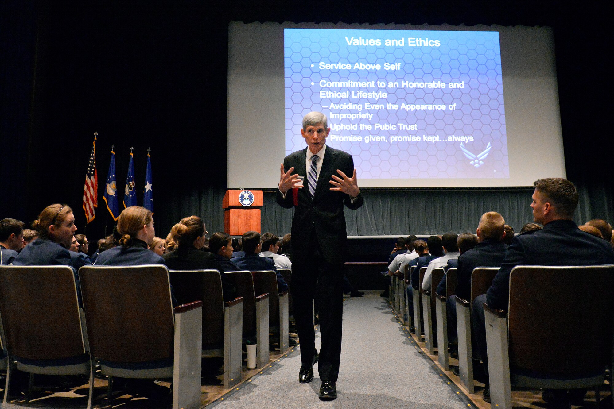 Retired Gen. Norton Schwartz, 1973 Academy graduate, walks through an aisle of cadets and Academy staff as he speaks to them about values and ethics at the 2014 National Character and Leadership Symposium Feb. 28. 