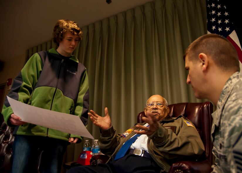 Retired Lt. Col. Hiram Mann, a Tuskegee Airman, talks to Master Sgt. Kevin Lukehart, 437th Operations Group, and his son Tyler, during a visit to the 16th Airlift Squadron March 6, 2014, at Joint Base Charleston – Air Base, S.C. During his career, Mann flew the P-40 "Warhawk" and the P-47 "Thunderbolt" fighter-type aircraft, and co-piloted the B-25 "Billy Mitchell" bomber, the C-47 "Gooney-bird" and the C-45 "Expediter” cargo planes. (U.S. Air Force photo/Staff Sgt. William O’Brien)