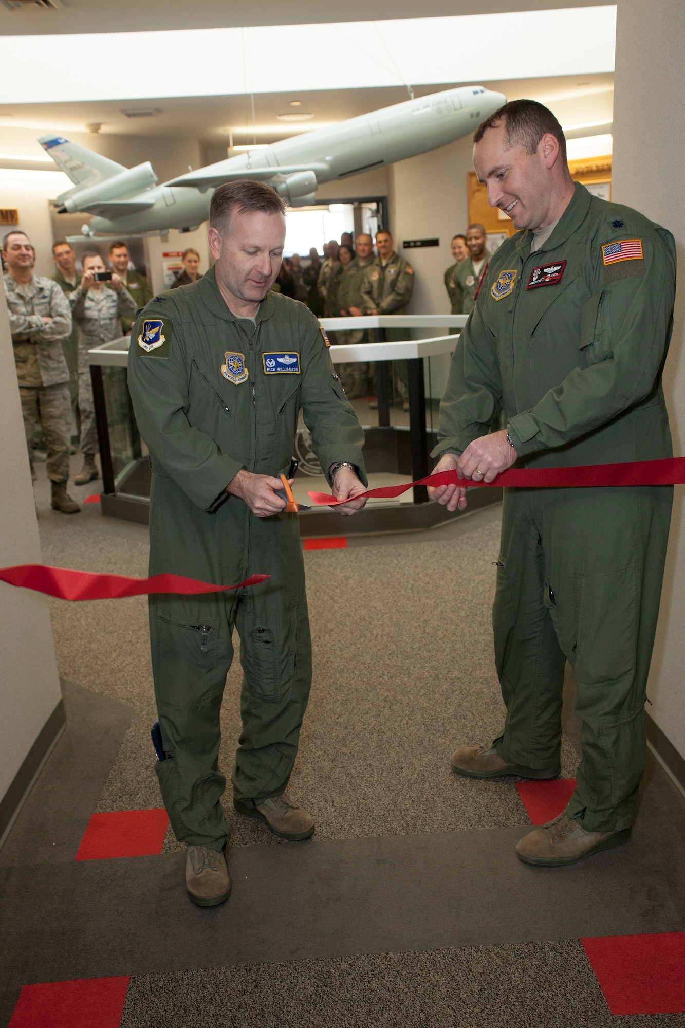 Col. Richard E. Williamson, Jr., 305th Air Mobility Wing commander, and Lt. Col. William Wade, 2nd Air Refueling Squadron commander, cut the ribbon opening the newly expanded 2nd ARS Operations Center Feb. 24, 2014, at Joint Base McGuire-Dix-Lakehurst, N.J. The new Ops Center consolidated the squadron aviation resource management, training, scheduling, mission planning and the assistant director of operations all into one location. (U.S. Air Force photo by Wayne Russell/Released)