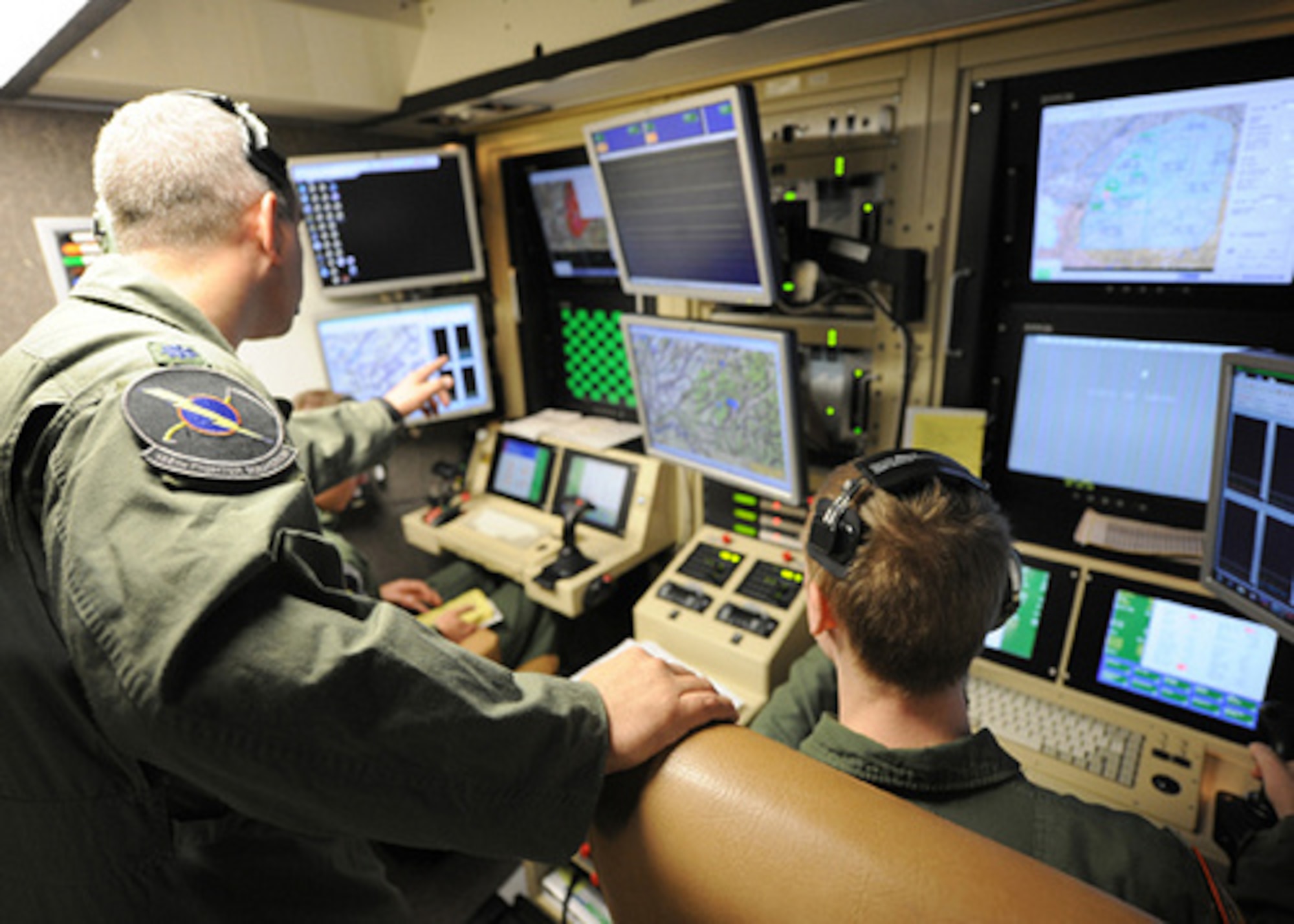 A student pilot and sensor operator man the controls of a MQ-9 Reaper in a ground-based cockpit during a training mission flown from Hancock Field Air National Guard Base, Syracuse, New York. (U.S. Air National Guard photo by Tech. Sgt. Ricky Best/Released)

