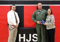 WRIGHT-PATTERSON AIR FORCE BASE, Ohio - Senior Master Sgt. Gregory Sersion, 445th Aeromedical Evacuation Squadron, presents a flag he brought back from his deployment to Katie Treherne, Hopewell Junior School teacher, in honor of the school Feb. 19, 2014, as the school’s principal, Jeff Rouff looks on. Treherne’s 7th grade Information Technology I classes mailed more than 115 letters to Sersion while he was deployed. (Courtesy photo)