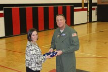 WRIGHT-PATTERSON AIR FORCE BASE, Ohio - Senior Master Sgt. Gregory Sersion, 445th Aeromedical Evacuation Squadron, presents a flag he brought back from his deployment to Hopewell Junior School teacher Katie Treherne, in honor of the school Feb. 19, 2014. Treherne’s 7th grade Information Technology I classes mailed more than 115 letters to Sersion while he was deployed. (Courtesy photo)