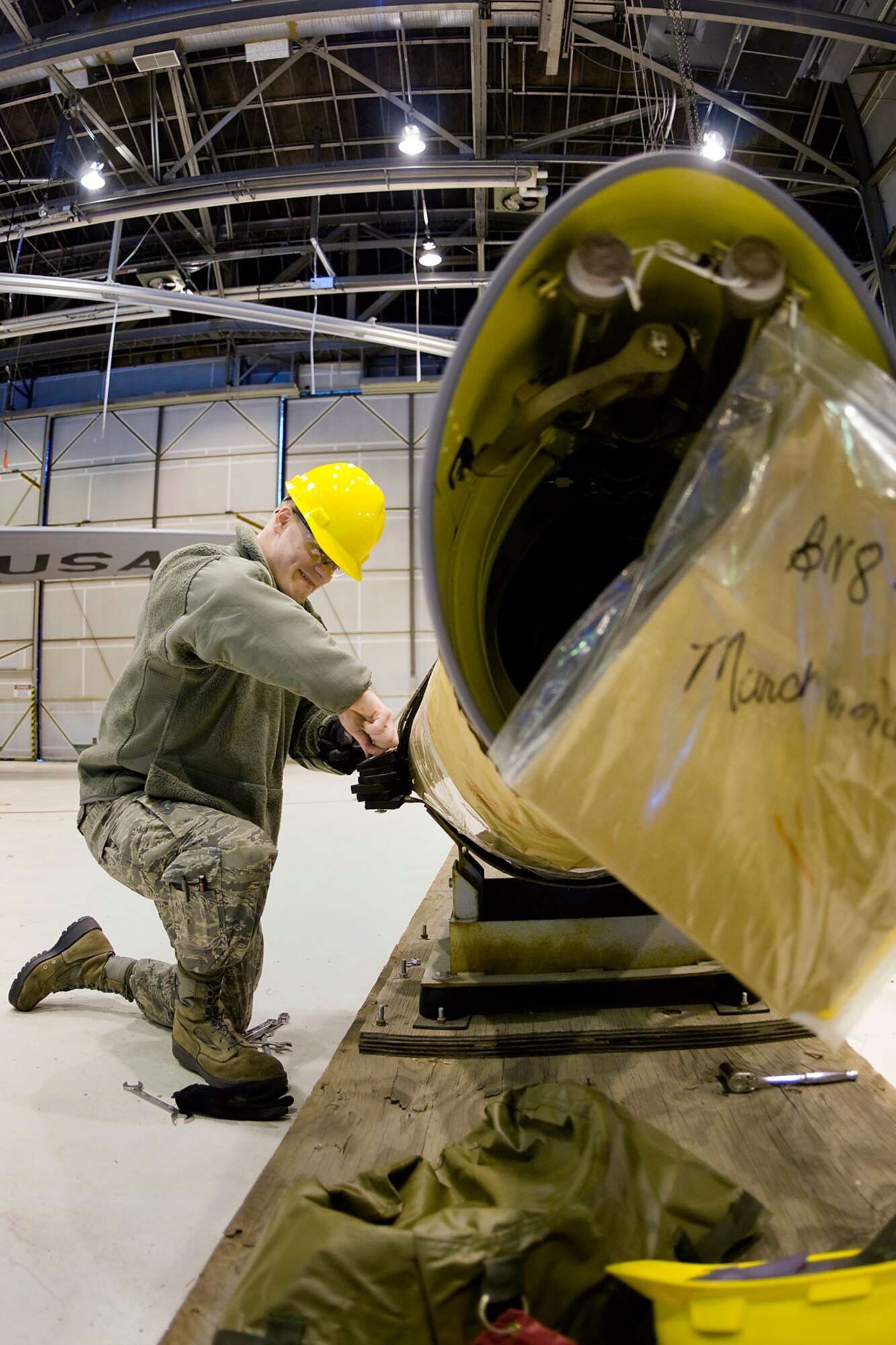 Senior Airman Joshua Christian, 434th Aircraft Maintenance Squadron aircraft hydraulic systems specialist, works to remove a new KC-135R Stratotanker boom from its crate at Grissom Air Reserve Base, Ind., Feb. 24, 2014. The new boom was installed on one of Grissom's KC-135s shortly after. (U.S. Air Force photo/Tech. Sgt. Mark R. W. Orders-Woempner)
