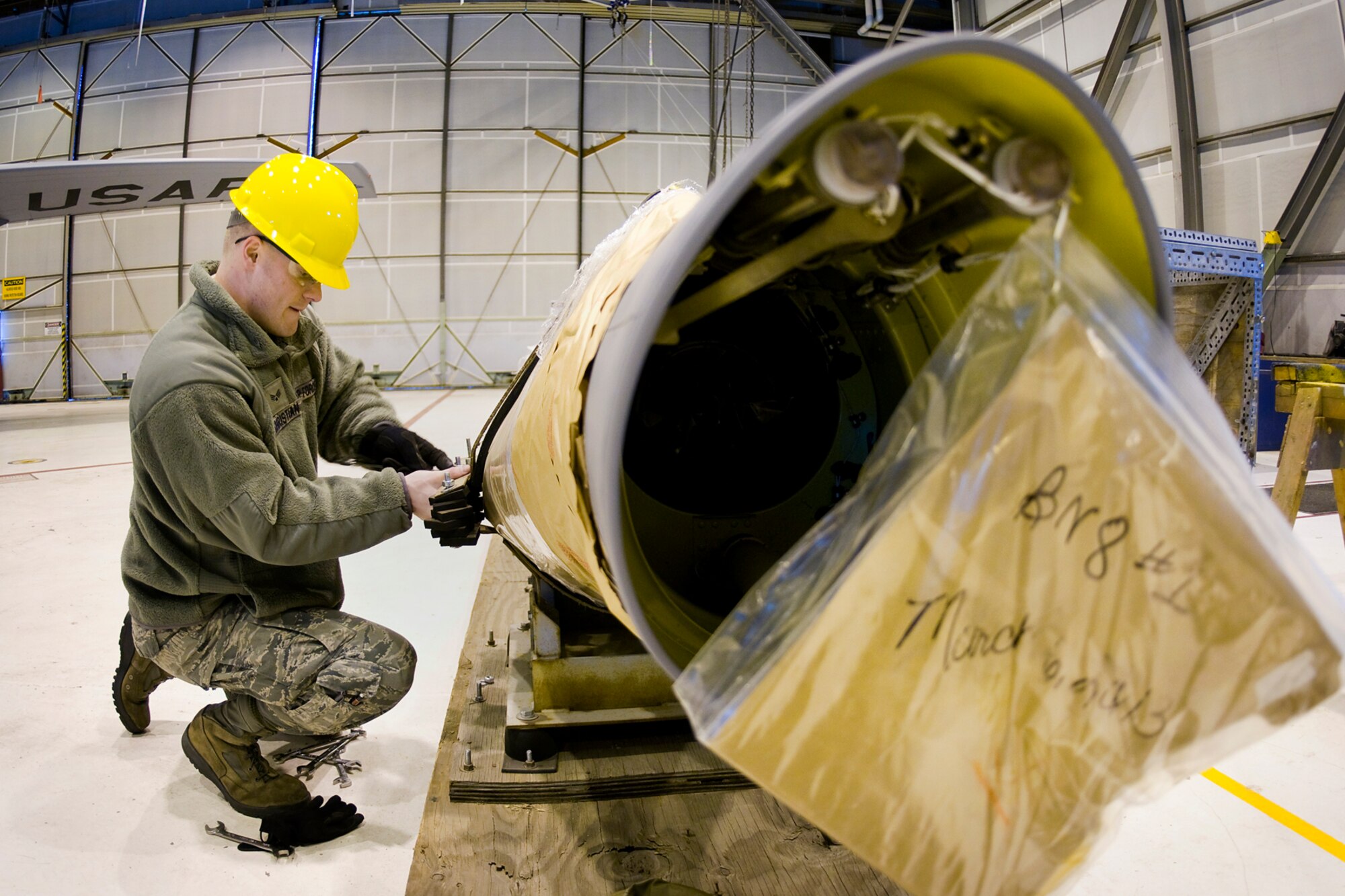 Senior Airman Joshua Christian, 434th Aircraft Maintenance Squadron aircraft hydraulic systems specialist, works to remove a new KC-135R Stratotanker boom from its crate at Grissom Air Reserve Base, Ind., Feb. 24, 2014. The new boom was installed on one of Grissom's KC-135s shortly after. (U.S. Air Force photo/Tech. Sgt. Mark R. W. Orders-Woempner)
