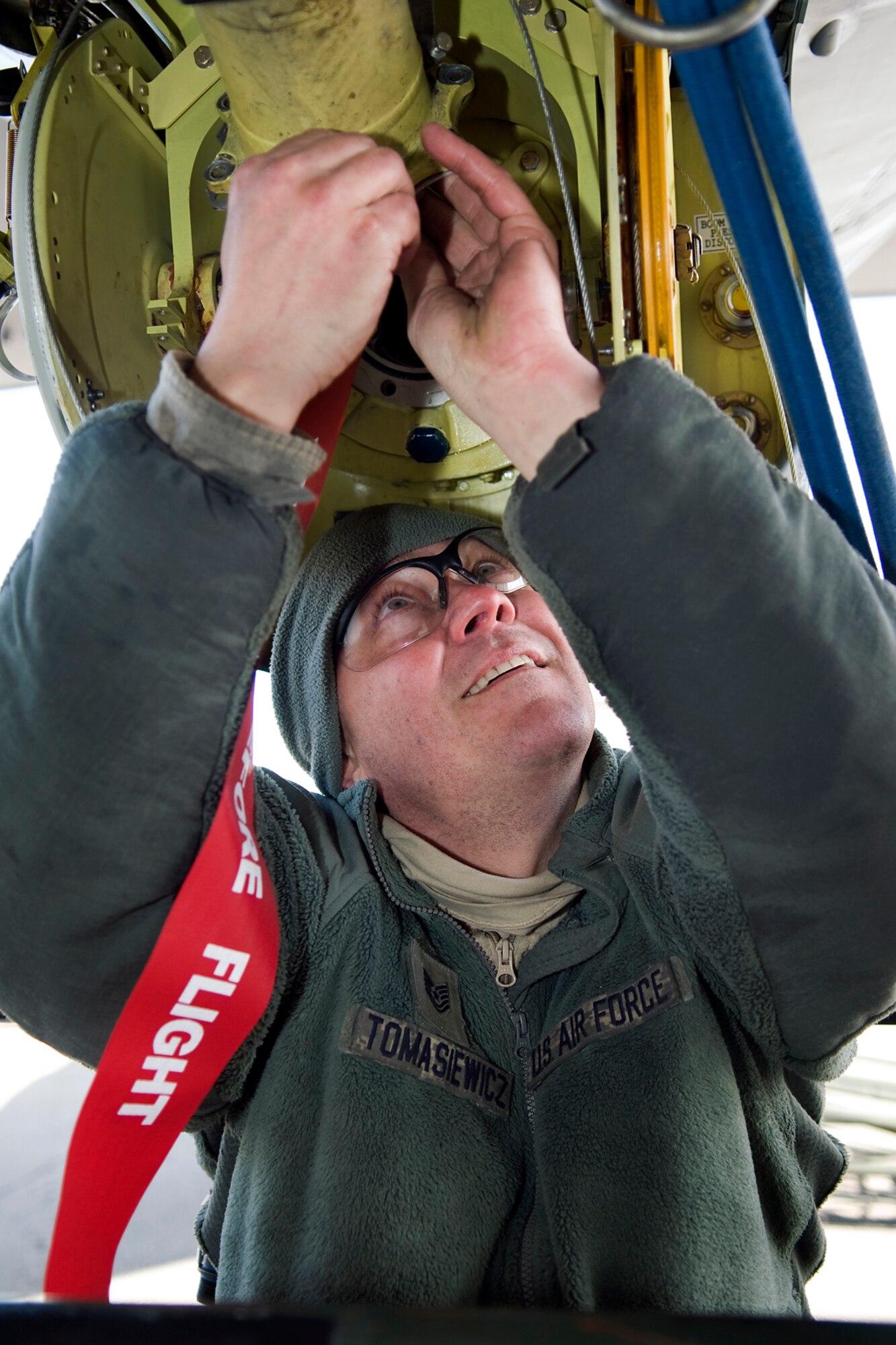 Tech. Sgt. Daniel Tomasiewicz, 434th Aircraft Maintenance Squadron aircraft pneudraulic technician, works to remove a boom from a KC-135R Stratotanker at Grissom Air Reserve Base, Ind., Feb. 24, 2014. The boom needed to be removed for repair after an unidentified noise was discovered. (U.S. Air Force photo/Tech. Sgt. Mark R. W. Orders-Woempner)
