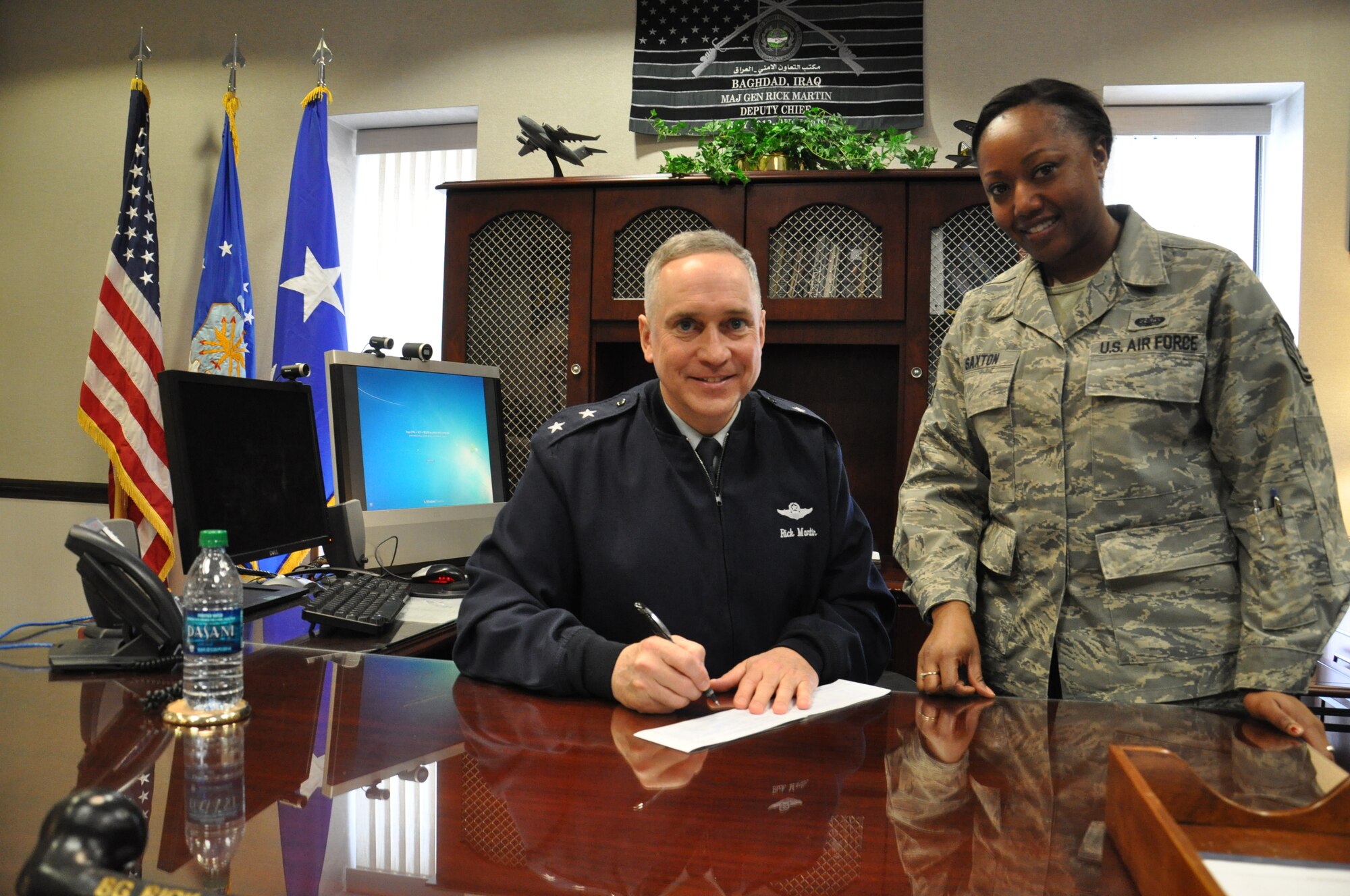 JOINT BASE MCGUIRE-DIX-LAKEHURST, N.J.--Maj. Gen. Rick Martin, U.S. Air Force Expeditionary Center commander, signs his Air Force Assistance Fund donation slip with Tech. Sgt. Latoya Saxton, USAFEC Knowledge Operations Management flight chief and AFA representative March 7, 2014. Each year, the AFAF campaign raises money in support of Airmen around the world.  (U.S. Air Force photo by Capt. Brooke Brzozowske) 