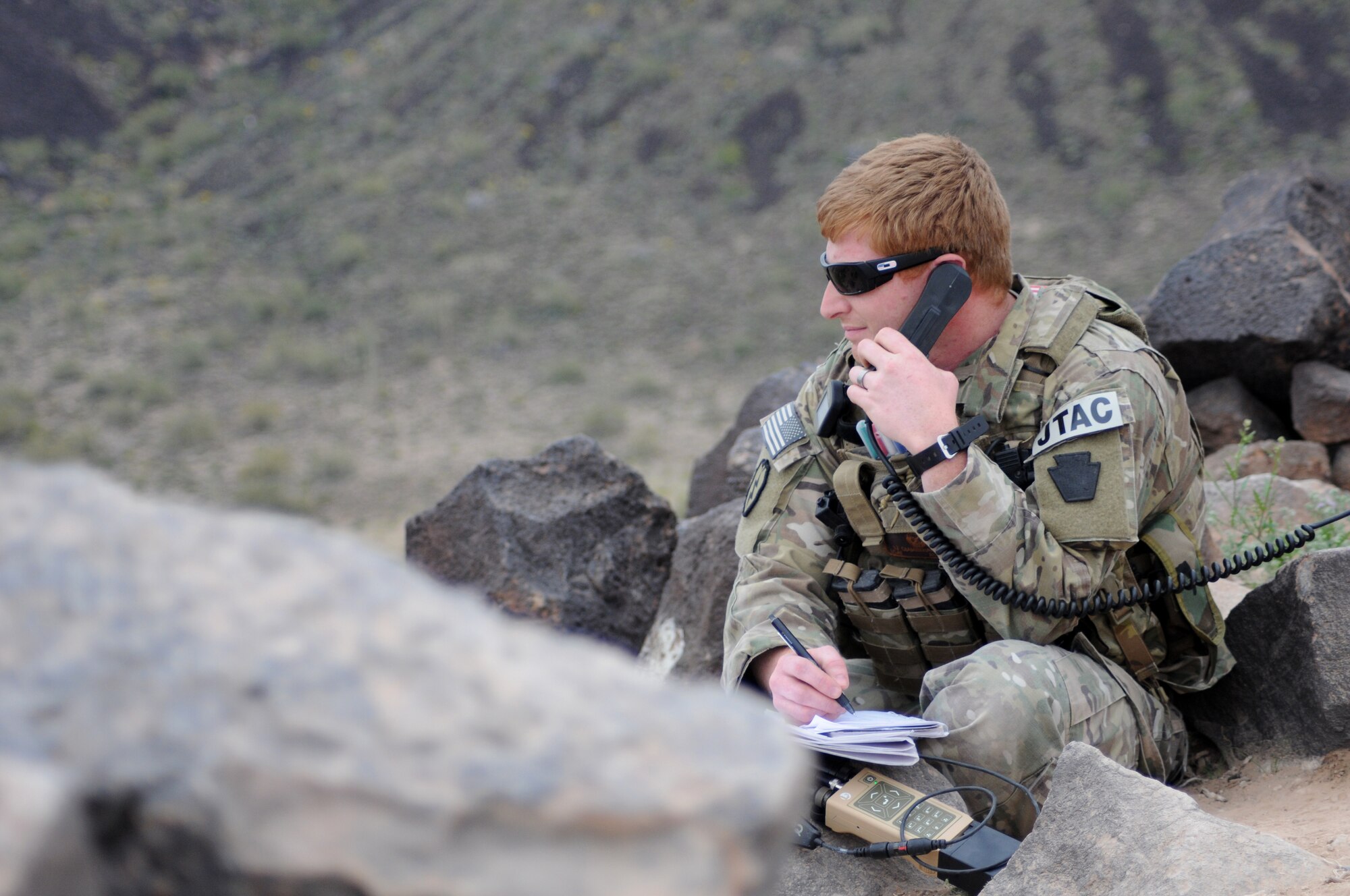 A picture of U.S. Air Force 2nd Lt. Keith A. Giamberardino, an air liaison officer, using a radio.