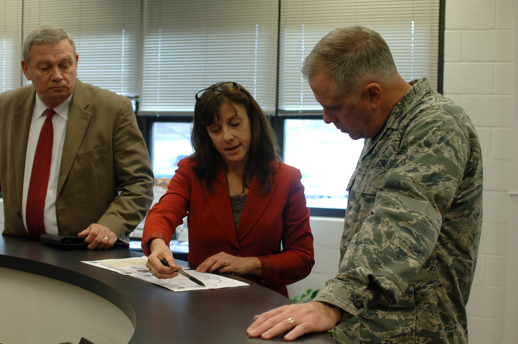 Donna Fontes, Soldier and Family Services branch chief, discusses programs available at the Army Community Service to U.S. Air Force Col. John J. Allen Jr., Joint Base Langley-Eustis installation commander, and John Volkers, 733rd Force Support Division director, during a visit to Fort Eustis, Va., Mar. 6, 2014. Allen toured the facilities to better understand U.S. Army support services in comparison to Air Force programs. (U.S. Air Force photo by Senior Airman Teresa Aber/Released)