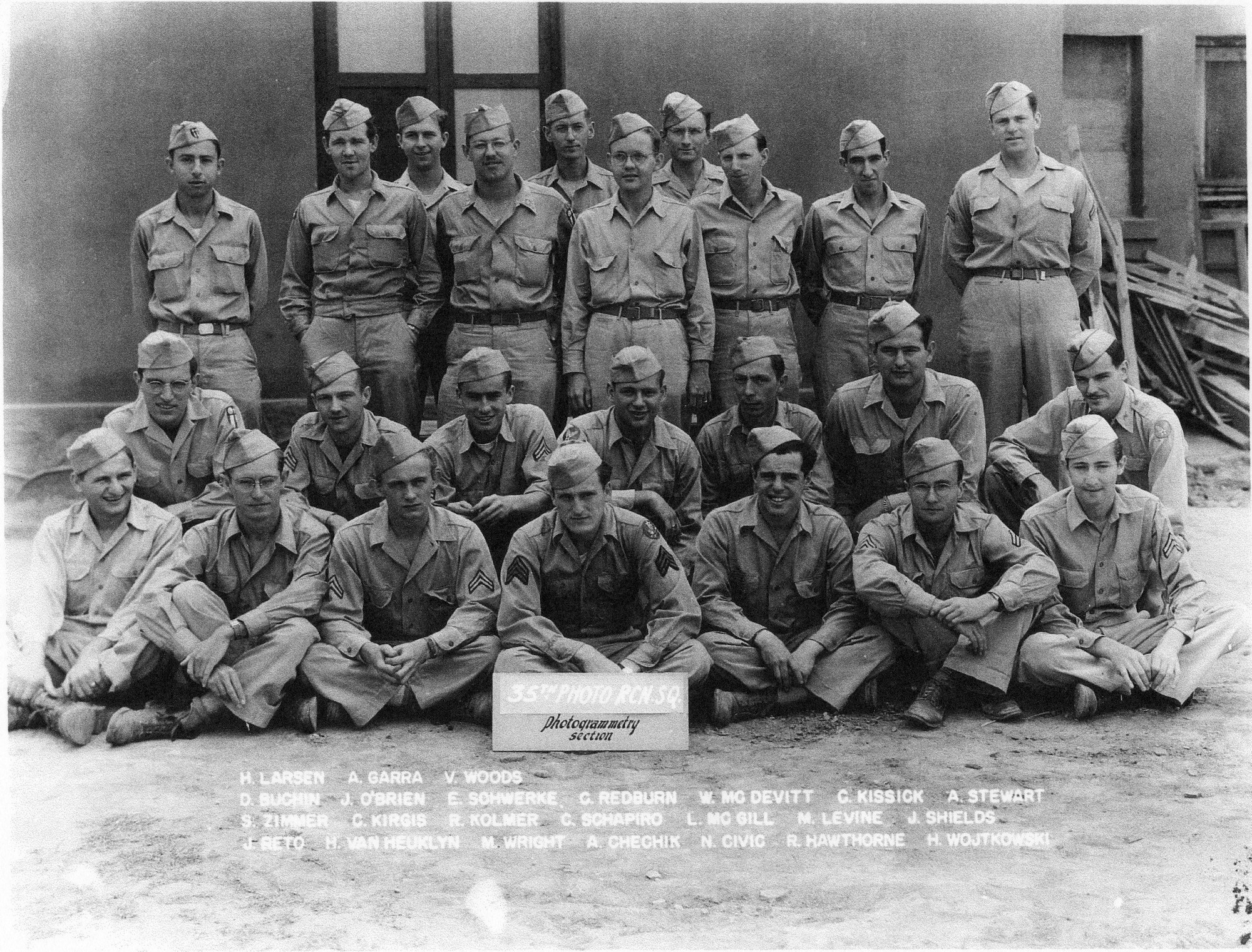 Members of the Redhawks, in the 35th Photo Reconnaissance Squadron’s Photogrammetry Section, pose for a photo at Kunming, China, in October of 1944, shortly after arriving in-country.  H. Allen Larsen is seen at left in the very back row.
