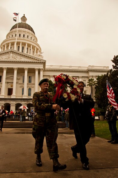 California Assemblyman Jim Frazier, D-Oakley, and a POW/MIA ceremony participant carry a wreath in honor of the fallen and missing in action servicemembers from the Vietnam conflict Feb. 27 during the opening ceremony of The Wall That Heals in Sacramento, Calif. (U.S. Air Force photo/Senior Airman Madelyn Brown)