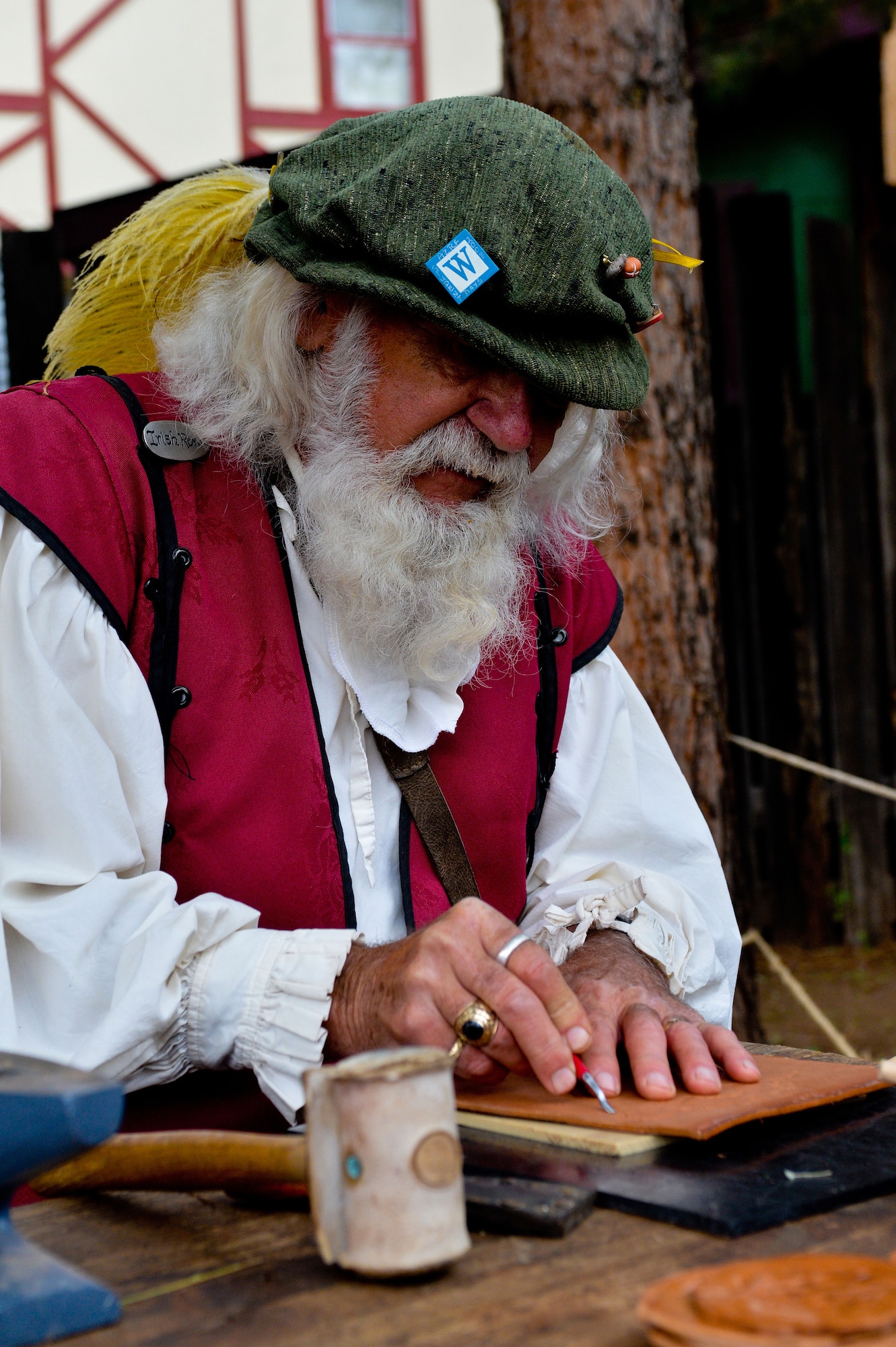 A leather artisan presses a pattern into a piece of leather at the Arizona Renaissance Festival in Apache Junction, Mar 9, 2013. Artisans at the festival make items ranging from essential oil perfumes, pewter and clay works to hand crafted and forged metalwork. (U.S. Air Force photo/Senior Airman Jason Colbert)