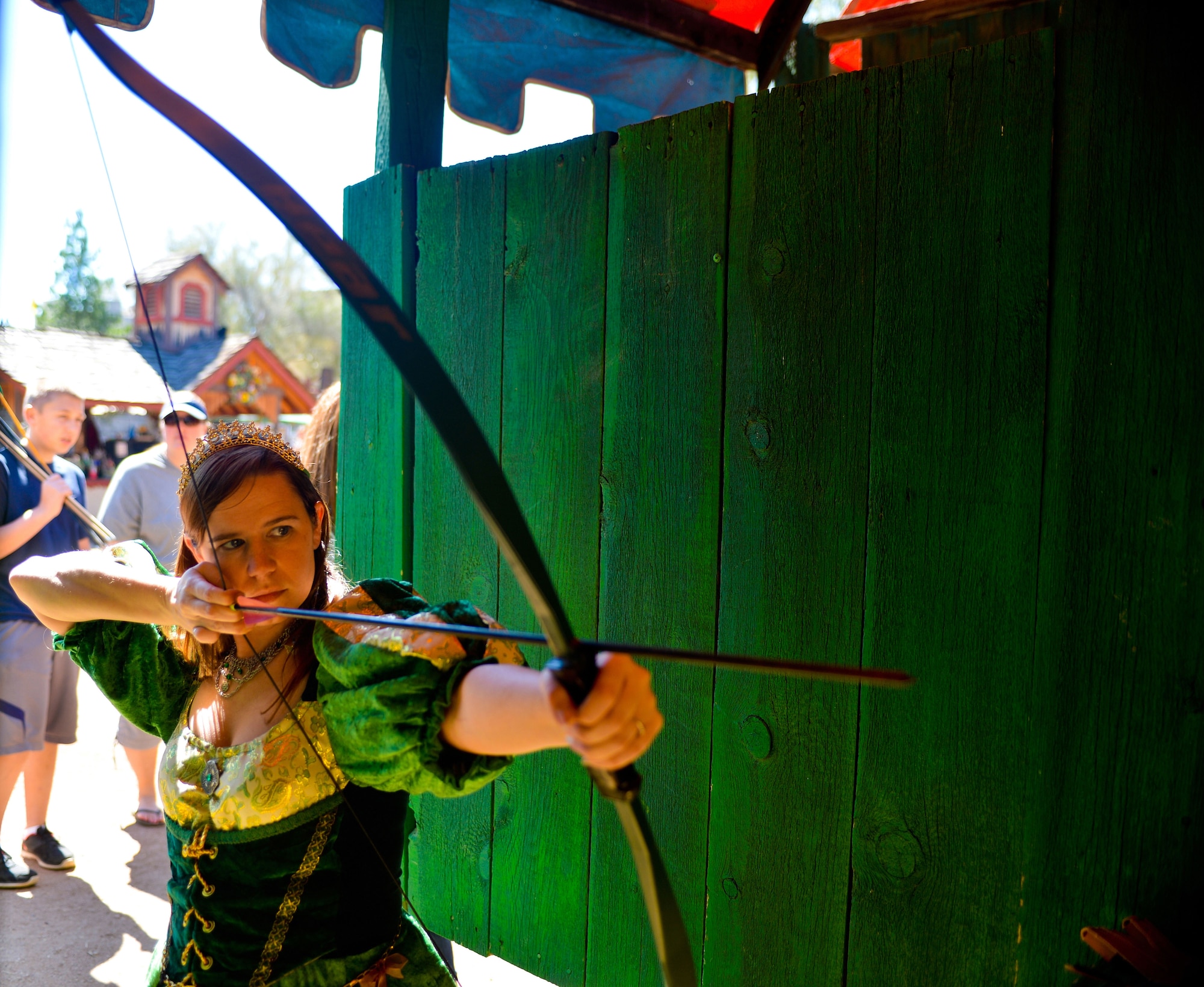 Tech. Sgt. Laurie Snyder, 56th Fighter Wing command post security manager, takes aim at a target at the archery booth at the Arizona Renaissance Festival in Apache Junction, Mar 10, 2013. Snyder and her family have attended the Arizona festival for four years. (U.S. Air Force photo/Senior Airman Jason Colbert)