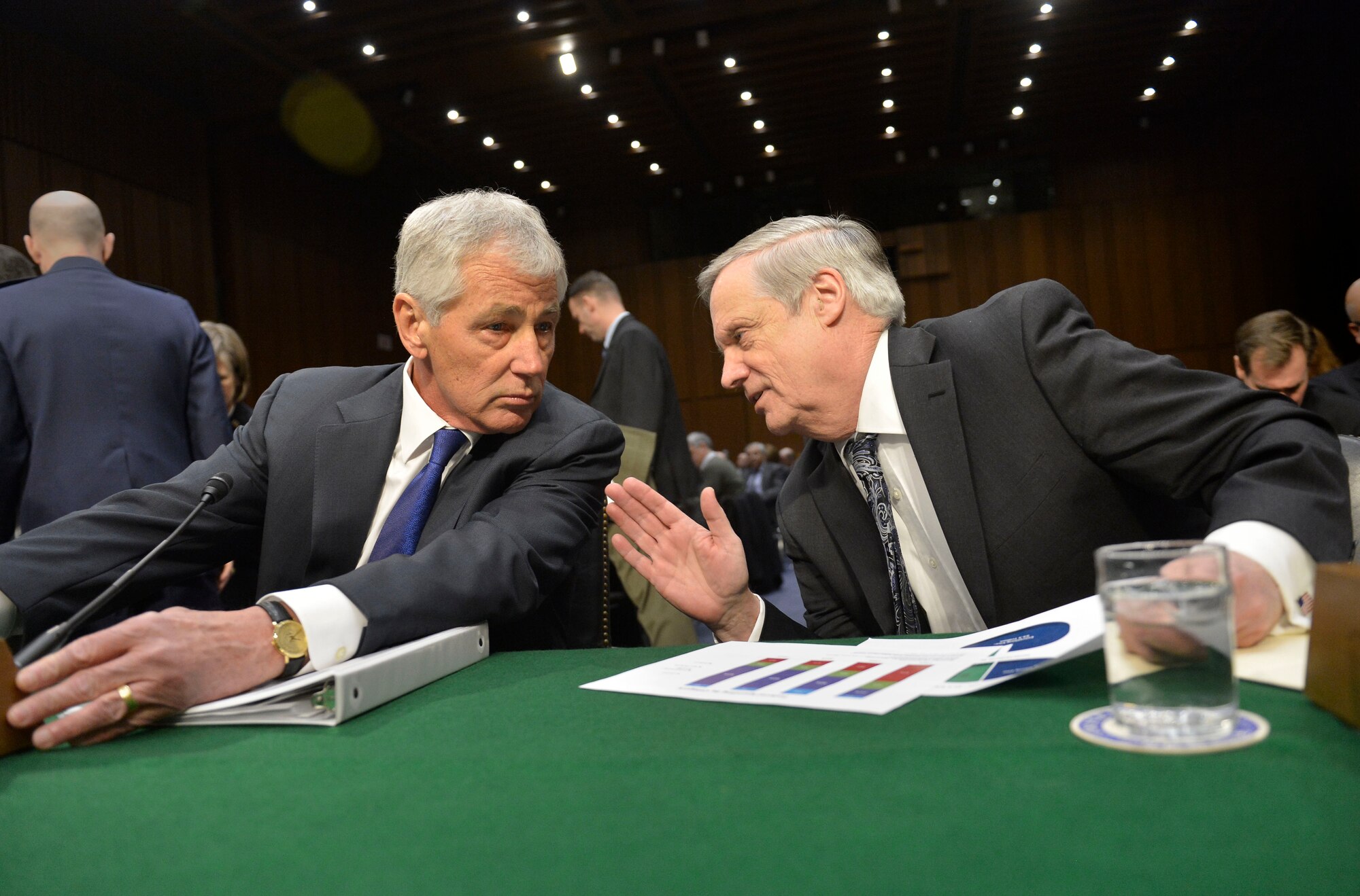 Defense Secretary Chuck Hagel, left, and Pentagon Comptroller Robert F. Hale confer as they prepare to testify before the Senate Armed Services Committee on the department's fiscal 2015 budget request in Washington on March 5, 2014. (DOD photo/Glenn Fawcett)	 