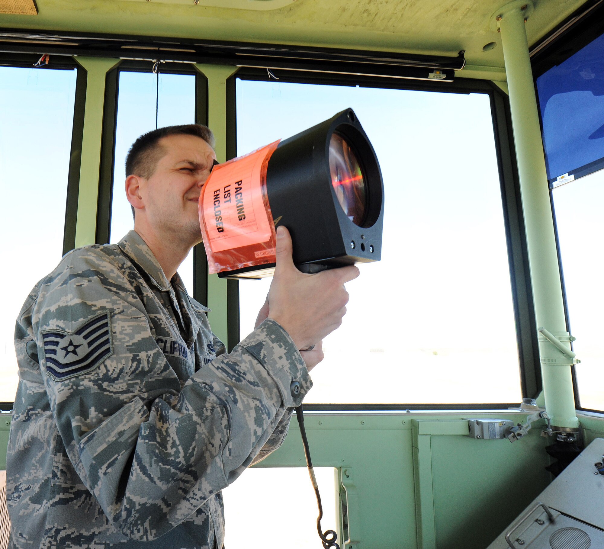 Tech. Sgt. Joshua Clifton, 54th CBCS air traffic control watch supervisor, aims a signal light from inside a mobile tower at the Perry-Houston County Airport. The airport provided a training site for the squadron to communicate with private aircraft. (U.S. Air Force photo by Tommie Horton)