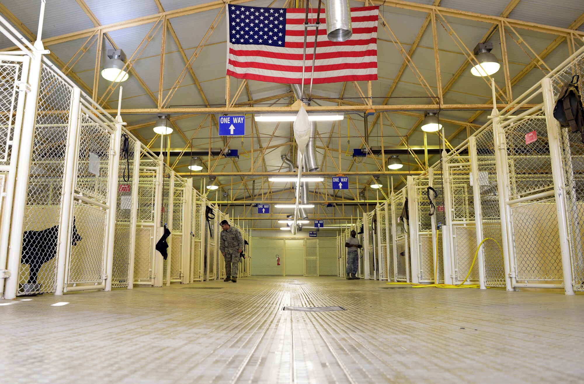 Staff Sergeants Carlos Cortez and Rodreques Boyd, 31st Security Forces Squadron military working dog handlers, check MWD kennels, March 6, 2014, at Aviano Air Base, Italy. Once a MWD team has met training requirements and seems to be a good fit, they are able to perform daily tasks to include patrolling the base, performing traffic stops and other duties security forces members are responsible for. (U.S. Air Force photo/Senior Airman Matthew Lotz)