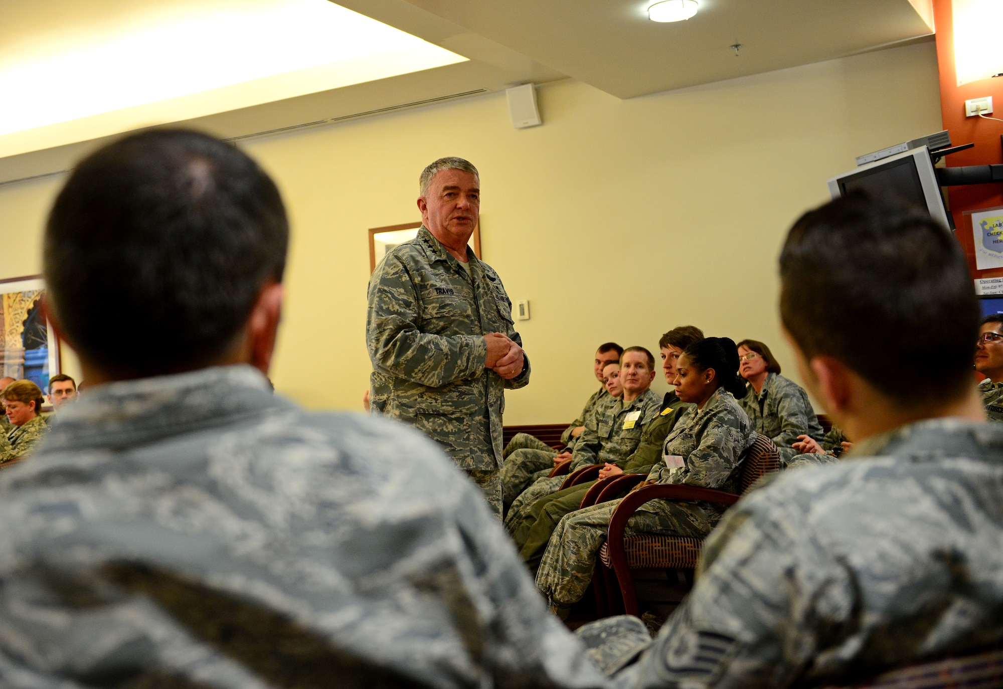 Lt. Gen. (Dr.) Thomas Travis, Surgeon General of the U.S. Air Force, speaks to 31st Medical Group Airmen, March 7, 2014, at Aviano Air Base, Italy. After a tour of the hospital, Travis spoke to the 31st MDG Airmen and answered questions about QUESTIONS. (U.S. Air Force Photo/Senior Airman Matthew Lotz)