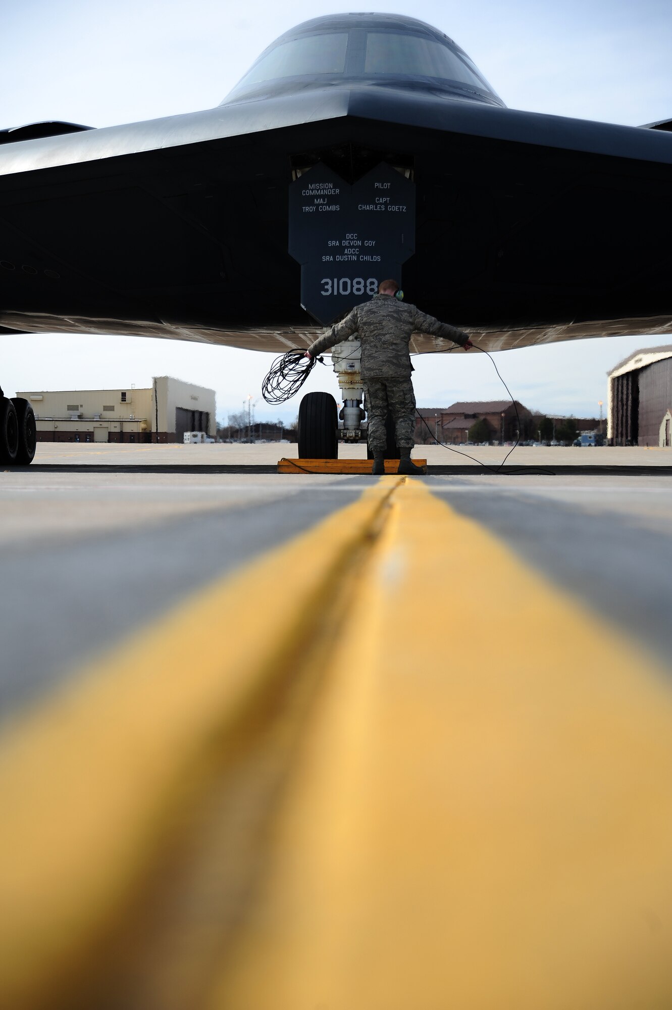 Airman 1st Class James Fulton, 509th Aircraft Maintenance Squadron crew chief, rolls up a communications cable after performing a pre-flight check on a B-2 Spirit at Whiteman Air Force Base, Mo., Feb. 24, 2014. Because of their mission and operations tempo, B-2 crew chiefs must remain alert and aware of every maintenance issue involving their assigned aircraft. (U.S. Air Force photo by Staff Sgt. Nick Wilson/Released)